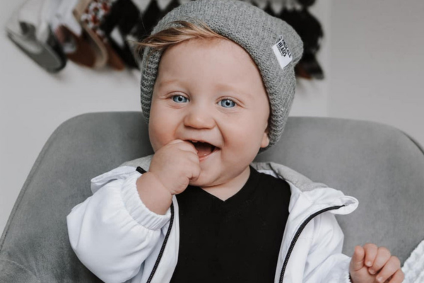 infant wearing a gray winter hat