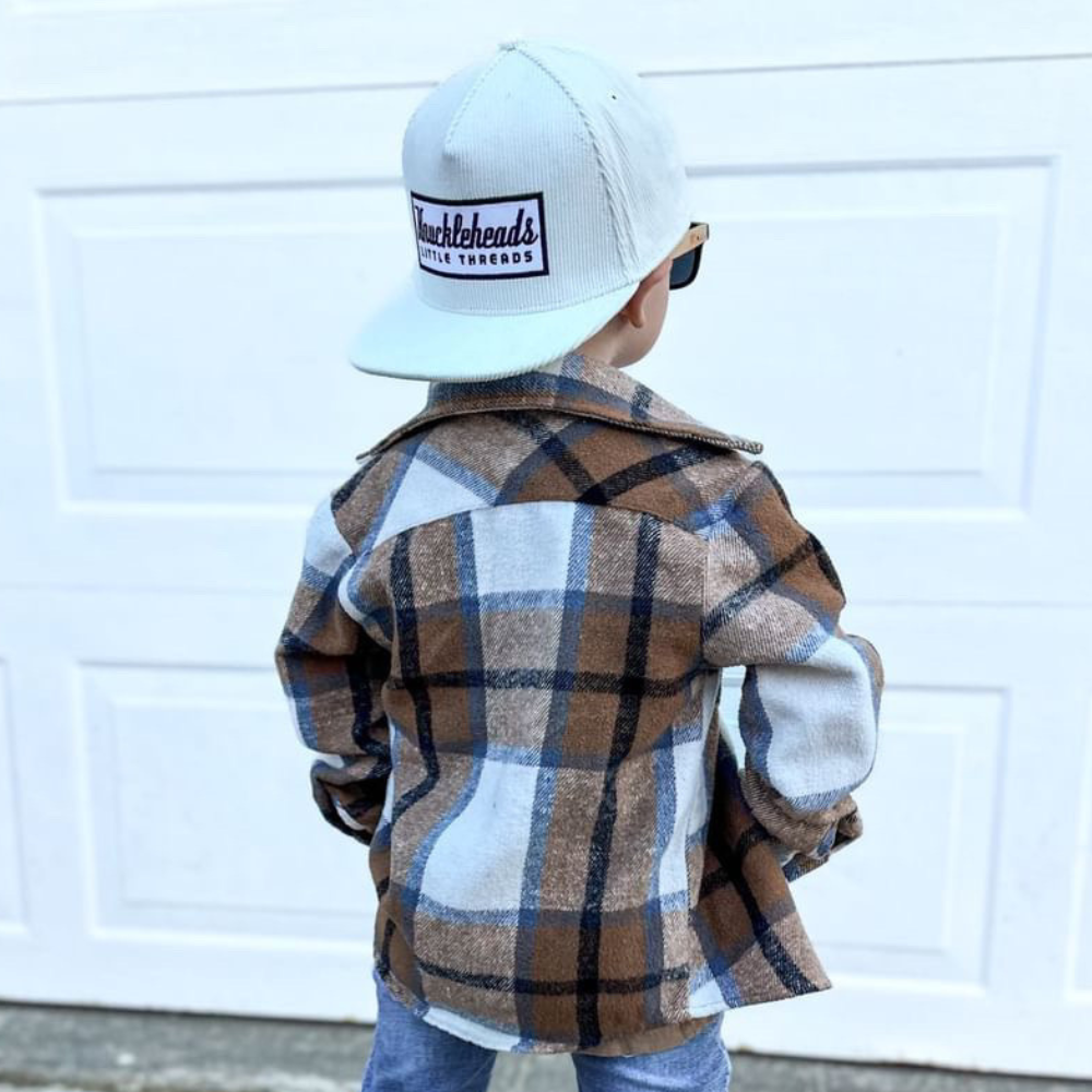 Image of White Corduroy Bill Kids Trucker Hat with Knuckleheads Patch: A cool and trendy trucker hat designed for kids. The hat features a stylish white crown and a white bill, adorned with a striking Knuckleheads patch on the front. Elevate your child's style with this fashionable and comfortable accessory, perfect for any adventure or everyday wear. Crafted with care, this grey with grey bill trucker hat with a Knuckleheads patch is a must-have addition to their wardrobe.