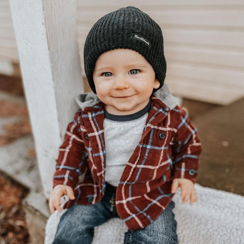 Snapshot of a timeless black kids' beanie from Knuckleheads, featuring the iconic brand tag. The beanie's understated style and versatile color make it a must-have accessory for young trendsetters.