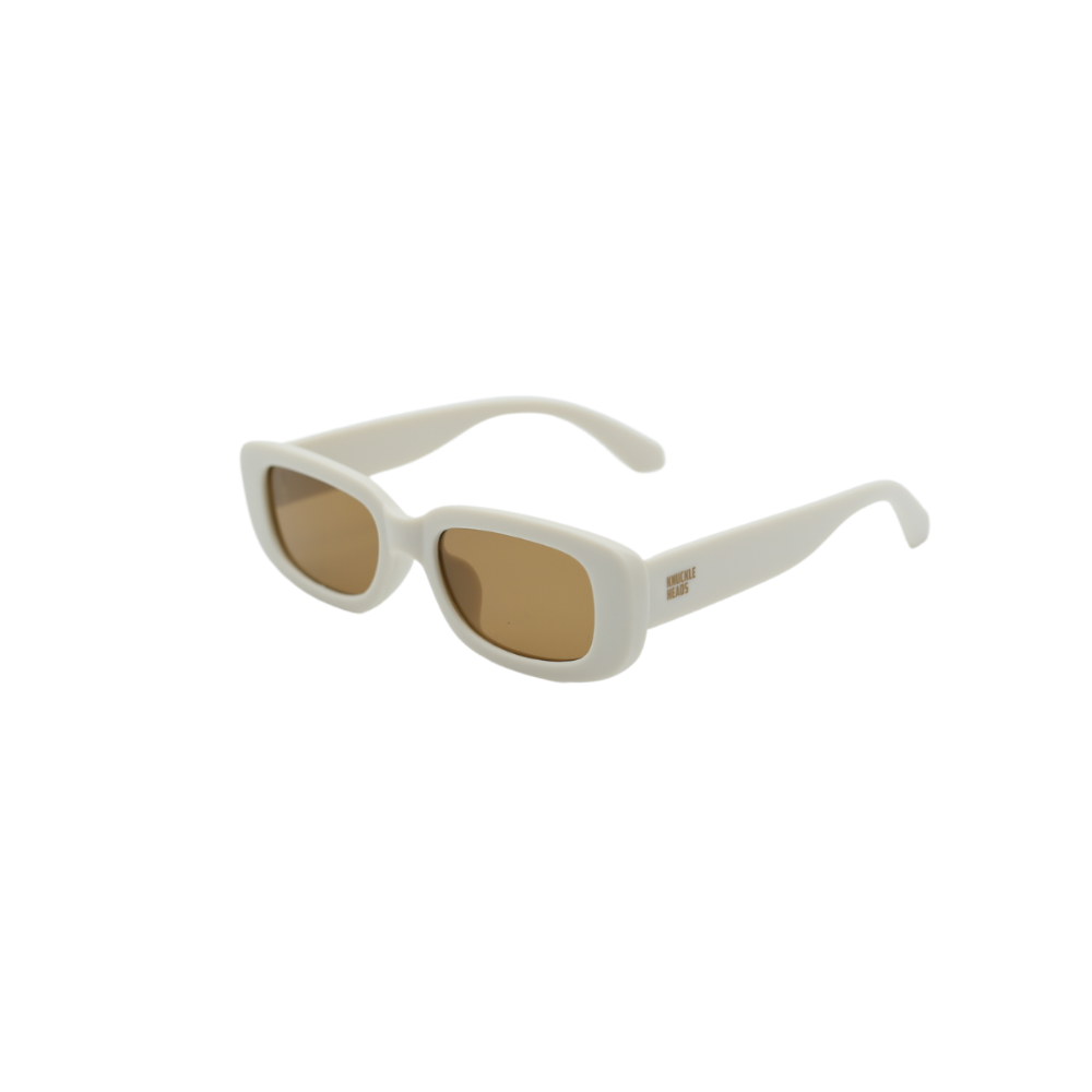 Image of the Audrey sunglasses with a redesigned frame and an Ivory finish. The temples showcase the Knuckleheads logo, projecting style and attitude. The lenses have a captivating goldish tint.
