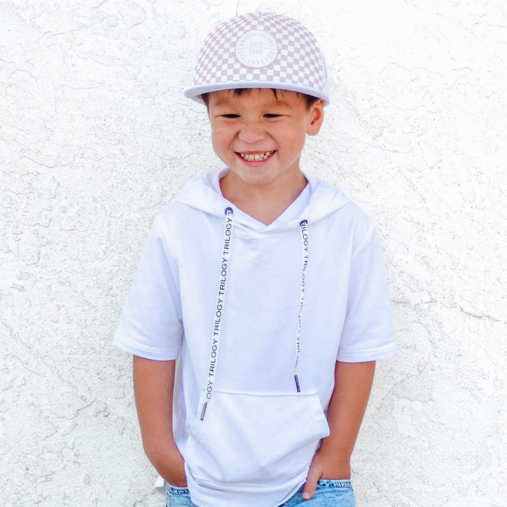 Image of White Kids Trucker Hat with Knuckleheads Patch and Checkered Pattern: A hip and stylish trucker hat designed for kids. The hat comes in crisp white and features a fashionable Knuckleheads patch adorned with a cool checkered pattern. Made with no sun mesh for a comfortable and breathable wear. Perfect accessory to elevate your child's style while providing sun protection.