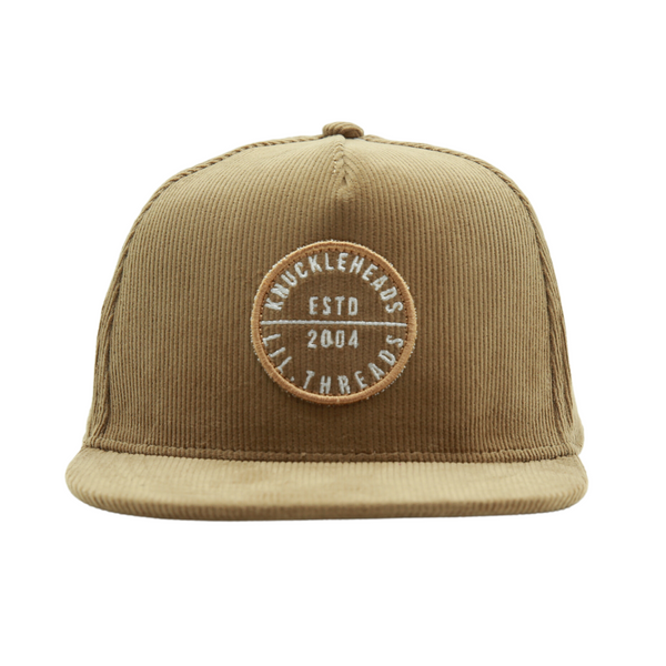 Introducing a Kids Trucker Hat in cozy Corduroy Camel, featuring an iconic Knuckleheads patch. This hat is specially designed for children, combining the warmth and style of corduroy with the classic Knuckleheads patch. A standout accessory in our collection, it adds a touch of charm and personality to your little one's look.