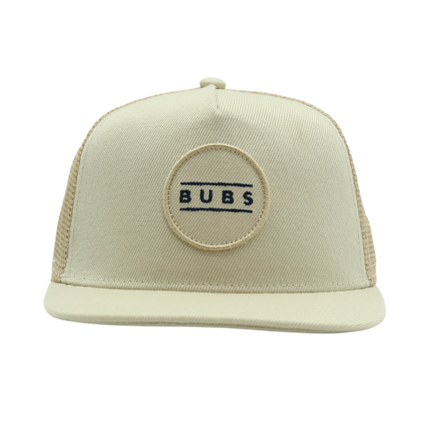 Image of an Oat Kids Trucker Hat with an endearing 'Bubs' patch and practical sun mesh. This charming hat combines a warm and inviting oat hue with the whimsical 'Bubs' patch, making it an attractive choice for children. Crafted with both style and functionality in mind, it includes sun mesh for added sun protection. This standout accessory adds personality and practicality to your little one's look.