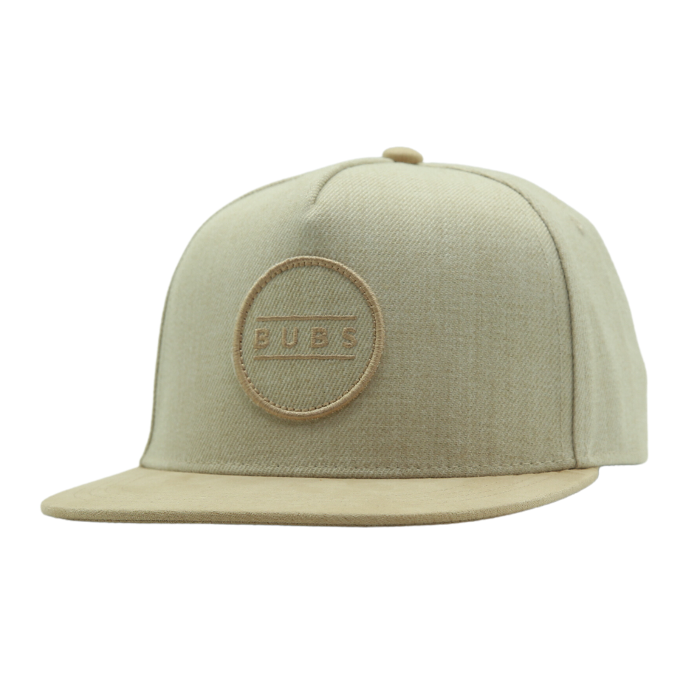 Image of an Oat Kids Trucker Hat featuring a delightful 'Bubs' patch. This charming hat combines a warm and inviting oat hue with the whimsical 'Bubs' patch, making it an attractive choice for children. Crafted with both style and comfort in mind, it's a standout accessory that adds personality to your little one's look.