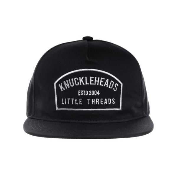 Image of Black Kids Trucker Hat with Knuckleheads Patch: A cool and trendy trucker hat designed for kids. The hat comes in sleek black, showcasing a striking Knuckleheads patch on the front. Elevate your child's style with this fashionable and comfortable accessory, perfect for any adventure or everyday wear. Crafted with care, this black trucker hat with a Knuckleheads patch is a must-have addition to their wardrobe.