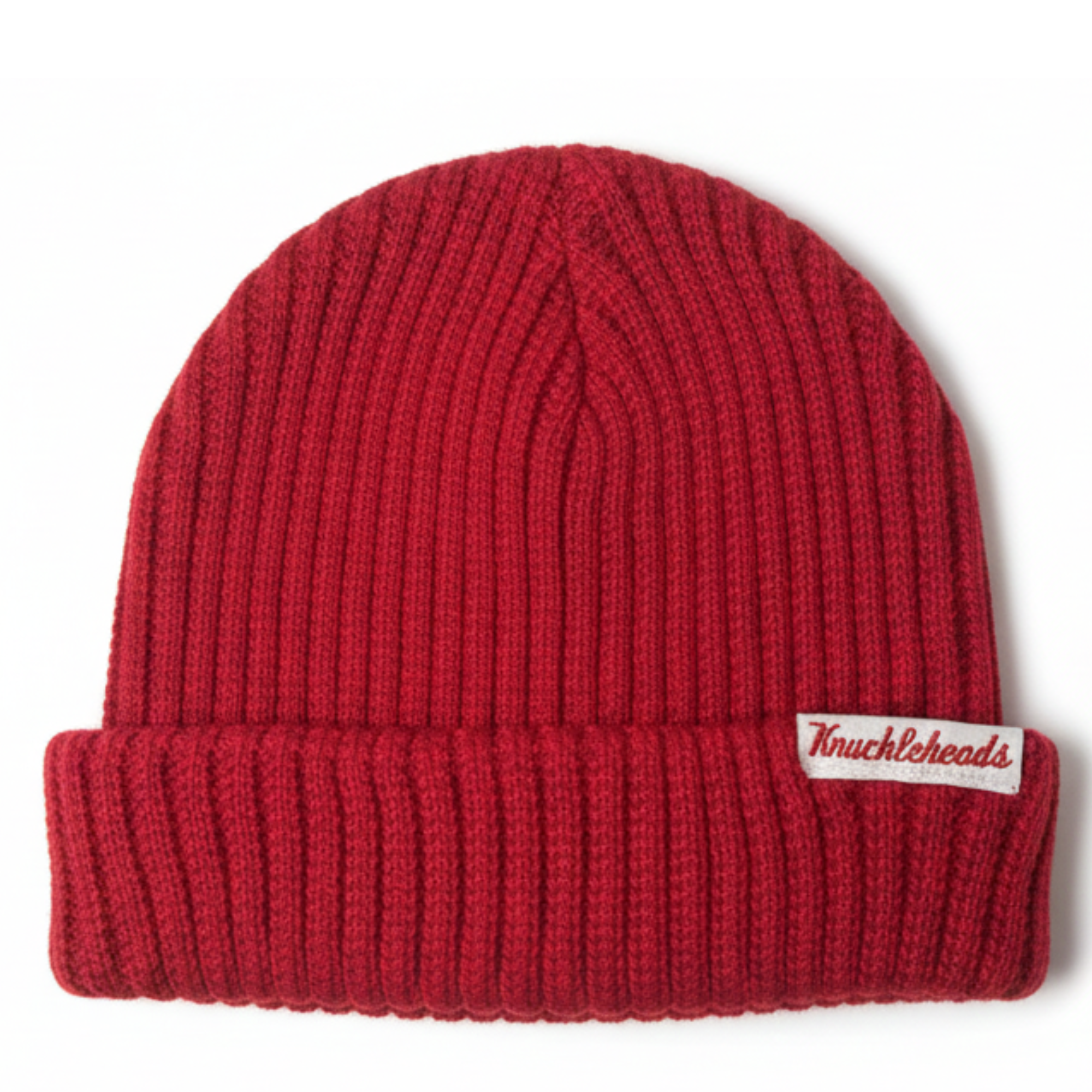 Cozy red knit beanie for infants and toddlers with a stretchy ribbed texture, folded cuff, and signature Knuckleheads tag — a warm, classic winter accessory.