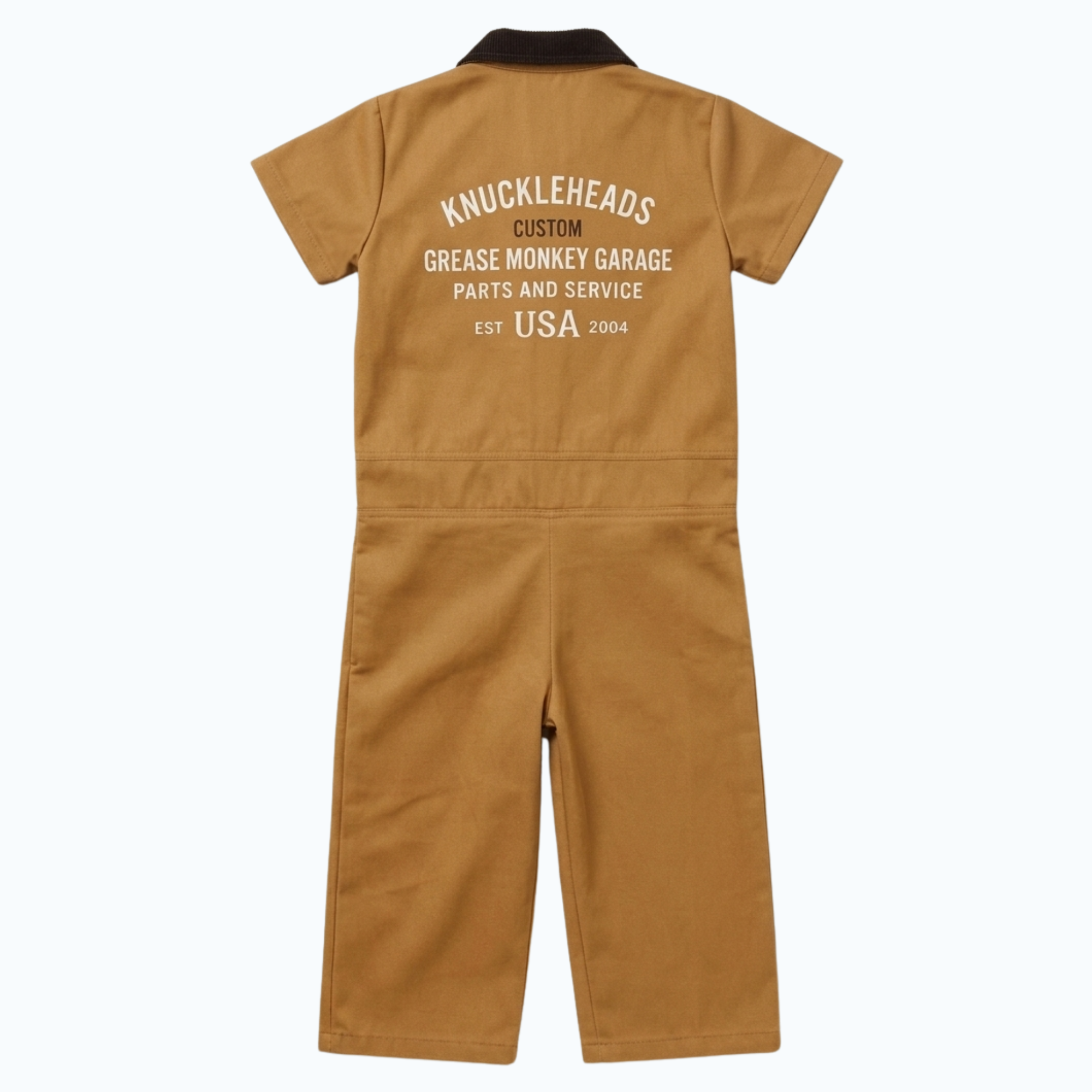 Back view of kids’ vintage tan garage coveralls featuring a dark brown corduroy collar and large Knuckleheads Grease Monkey Garage graphic print on the back.