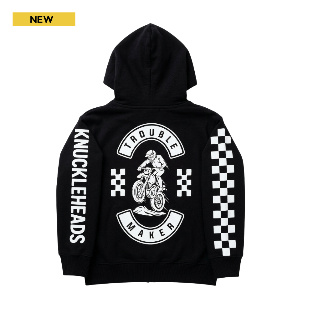 Black kids motocross zip hoodie with “Trouble Maker” dirt bike graphic, checkerboard racing sleeves, and Knuckleheads logo print.