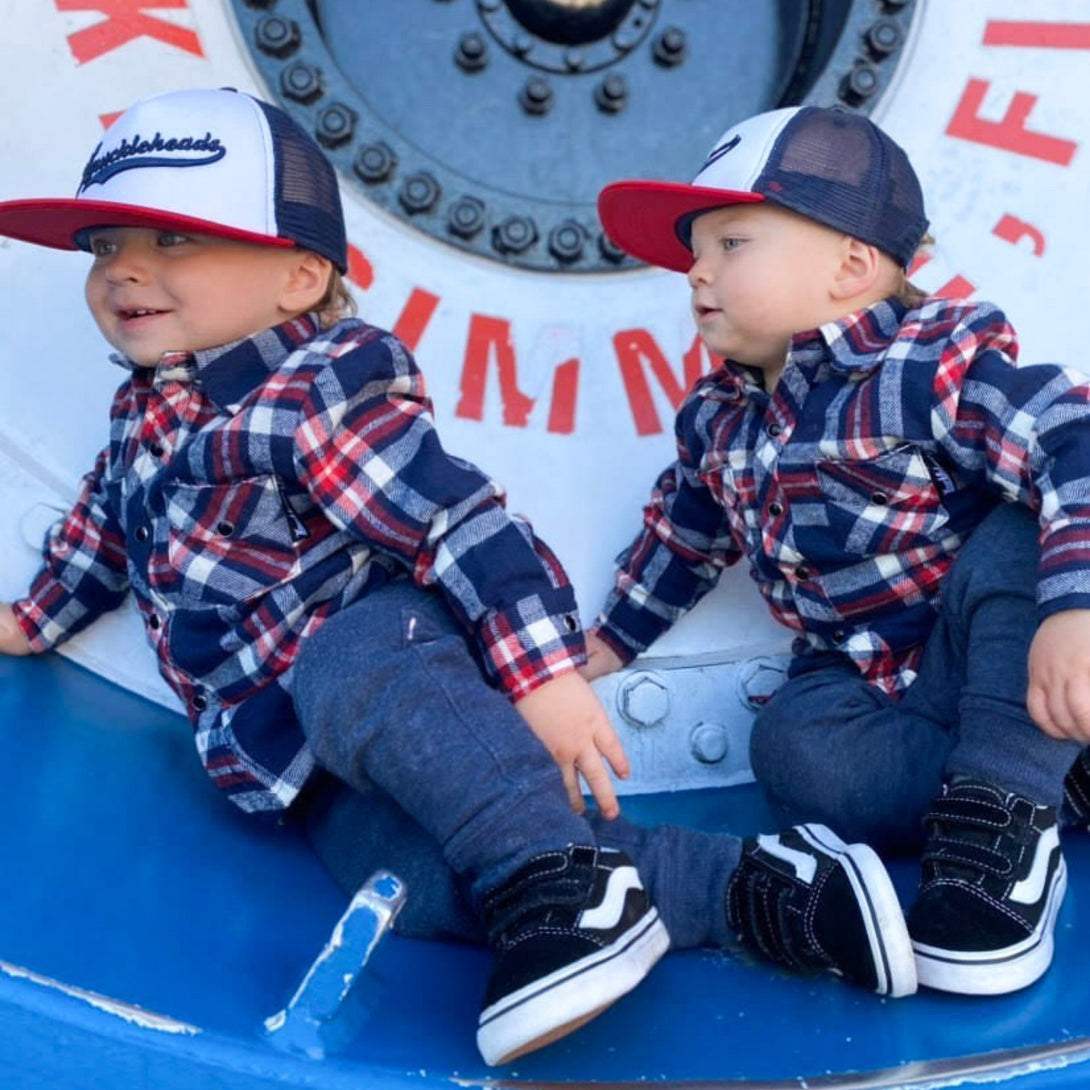 Image of Red, White, and Blue Kids Trucker Hat with Knuckleheads Patch: A patriotic and stylish accessory designed for kids. In vibrant red, white, and blue hues, it showcases a striking Knuckleheads patch on the front. Elevate your child's style with this fashionable hat, perfect for adding a touch of national pride to their outfits.