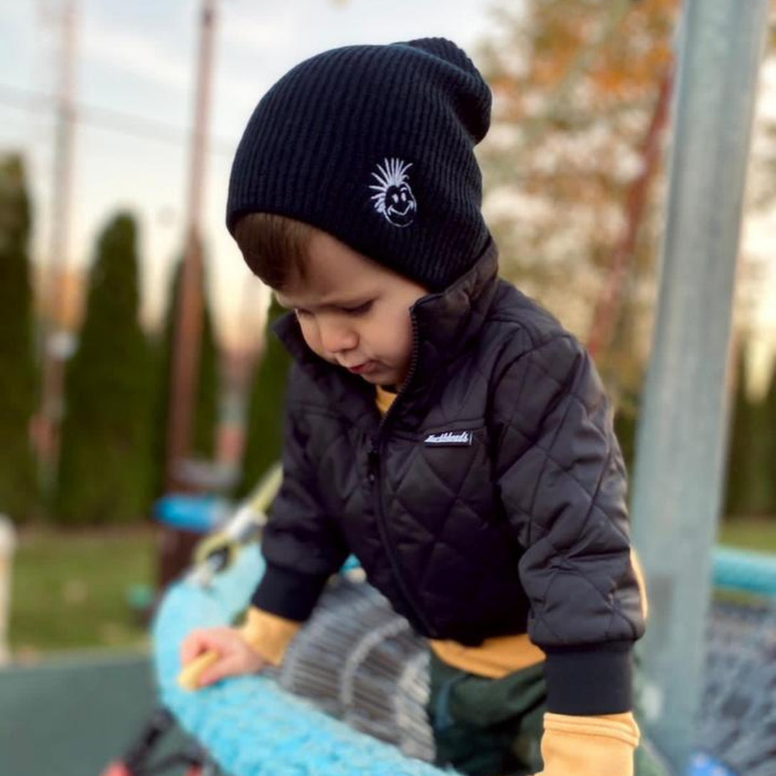 Introducing the Knuckleheads Children's Black Beanie – a timeless accessory designed to keep your little ones cozy and stylish. Crafted with care, this baby beanie features the iconic Knuckleheads brand tag and offers a classic design that complements any outfit. Whether your child is a baby or a toddler, this versatile beanie is the perfect addition to their wardrobe. Made with comfort in mind, it belongs to a collection of adorable infant hats that combine fashion and functionality effortlessly.