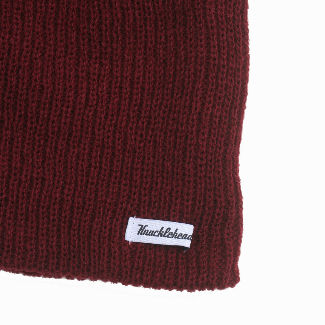 Image of a Knuckleheads Children's Burgundy Beanie, featuring its adaptable and cozy design tailored for infants and toddlers. Classic style adorned with the Knuckleheads brand tag. This Toddler beanie is part of a collection of charming Infant hats.