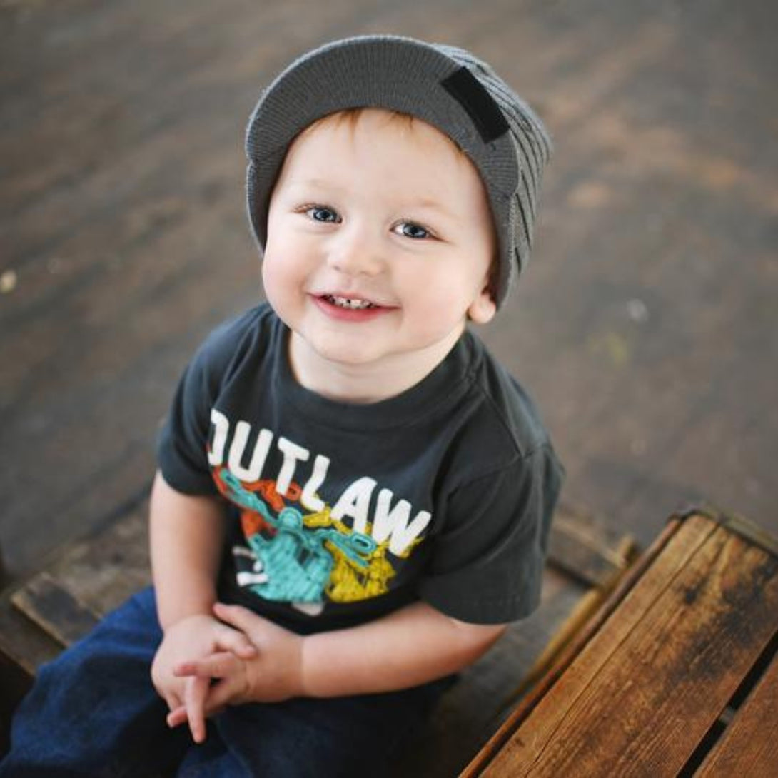 Image featuring a grey beanie with a visor and skull patterns, designed for children. This versatile beanie merges practicality with style, offering both a visor and edgy skull patterns. Perfect for infants and toddlers, it stands out within the collection of Infant hats, providing a unique combination of functionality and charm.