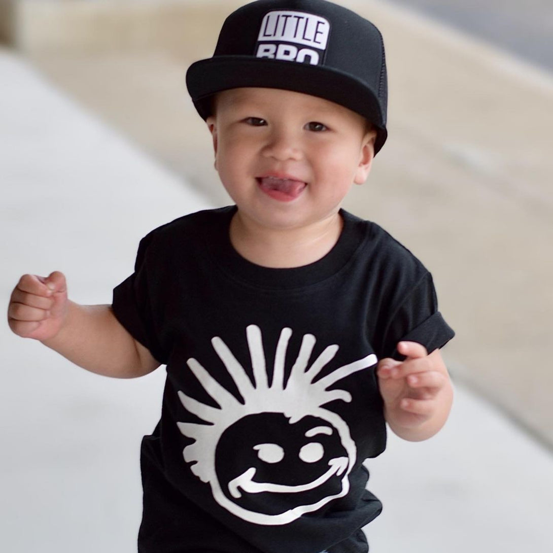 Image of Black Kids Trucker Hat with 'Little Bro' Patch: A trendy and stylish accessory designed for kids. In classic black, it features an adorable 'Little Bro' patch on the front. Elevate your child's style with this fashionable hat, perfect for adding a playful touch to their outfits. Crafted with care, this black kids trucker hat with the 'Little Bro' patch is a must-have addition to their wardrobe, suitable for various occasions and everyday wear.