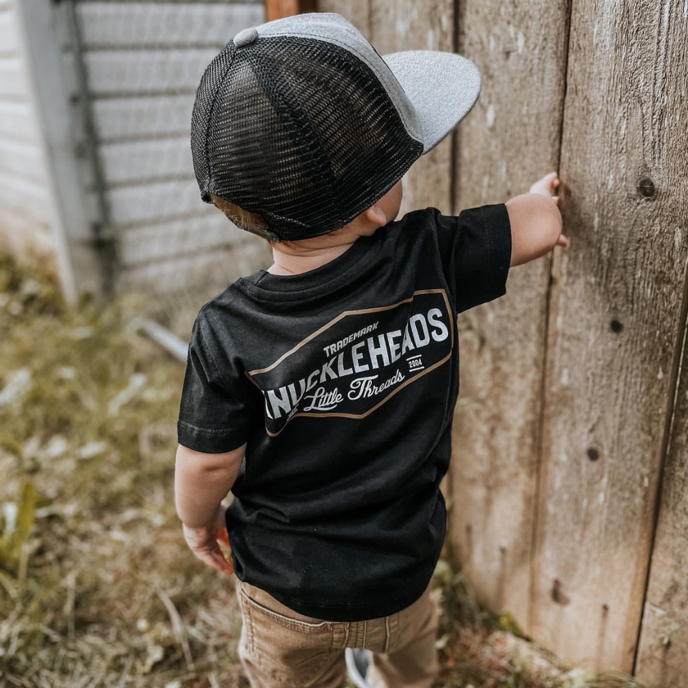 Image of Knuckleheads Black Classic Logo T-Shirt: A bold and stylish black tee featuring the iconic Knuckleheads logo. Crafted with premium materials for comfort and durability, this shirt is a versatile and fashionable choice for kids. The perfect statement piece for little fashionistas or cool dudes to stand out with confidence.