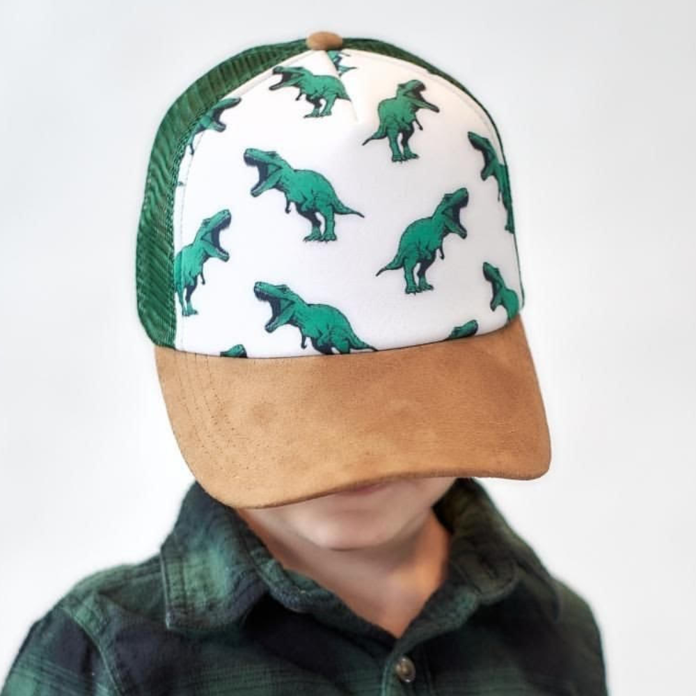 Image of Green Kids Trucker Hat with Dinosaurs Print: A playful and adventurous accessory designed for kids. In a vibrant green shade, it features a captivating dinosaurs print on the front. Elevate your child's style with this fun hat, perfect for adding a touch of prehistoric charm to their outfits. 