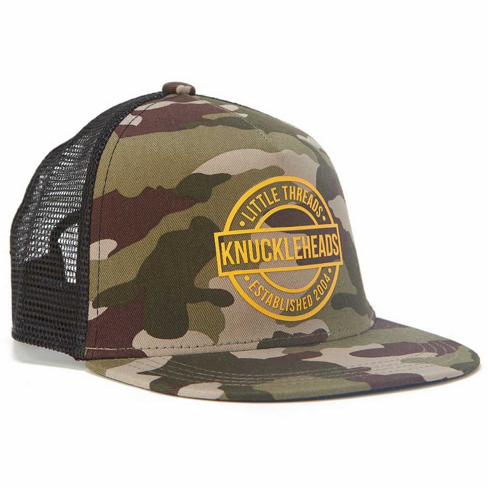 Image of Camo Kids Trucker Hat with Black Mesh and Gold Round Knuckleheads Patch: A rugged and stylish accessory designed for kids. In a classic camo pattern with black mesh, it features a distinctive gold round Knuckleheads patch on the front. Elevate your child's style with this fashionable hat, perfect for adding a touch of outdoor charm to their outfits.