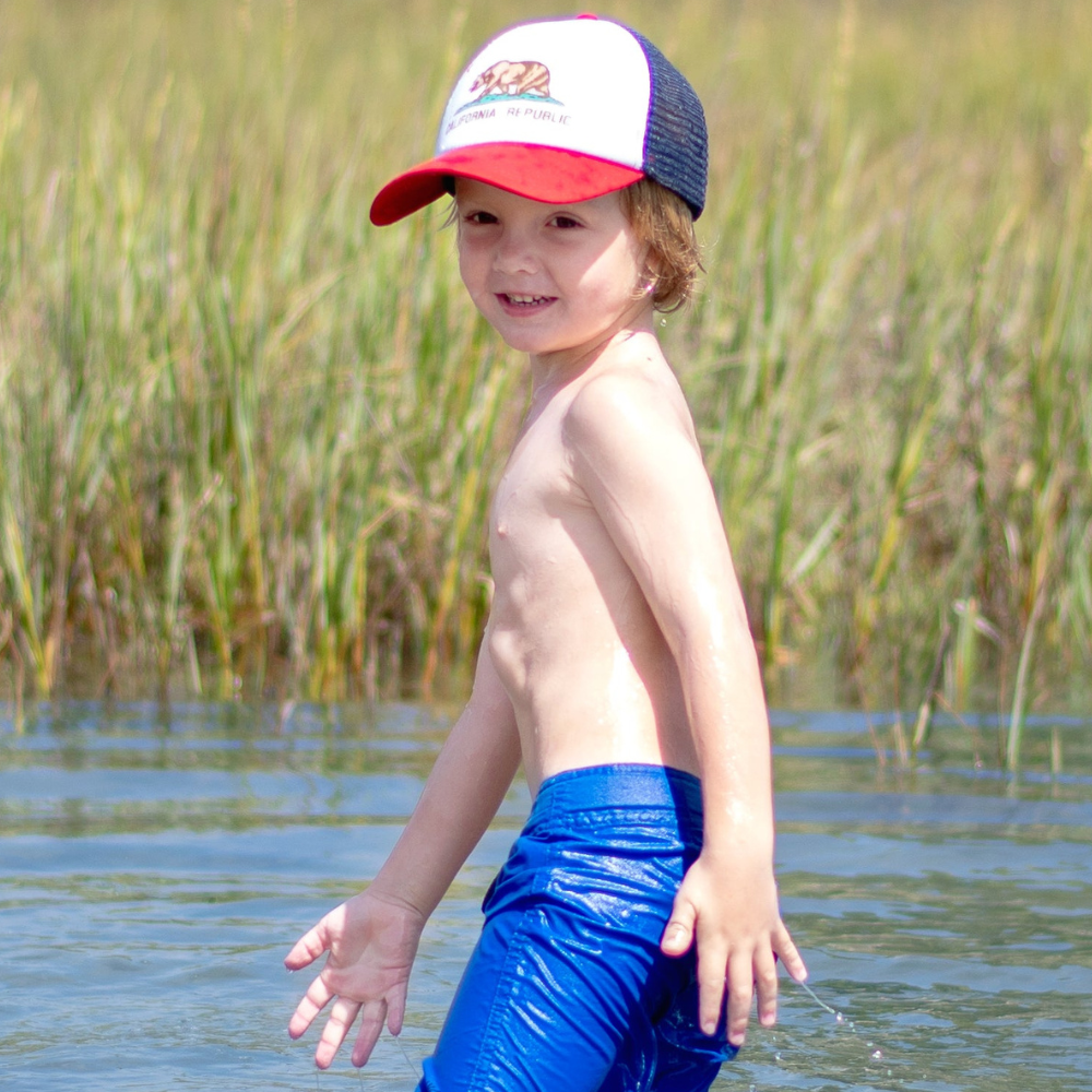 Image of Red, Blue, and White Kids Trucker Hat with California Republic Patch: A dynamic and stylish accessory designed for kids. Combining bold red, blue, and white hues, it showcases a captivating California Republic patch on the front. Elevate your child's style with this fashionable hat, perfect for expressing their connection to the Golden State. 