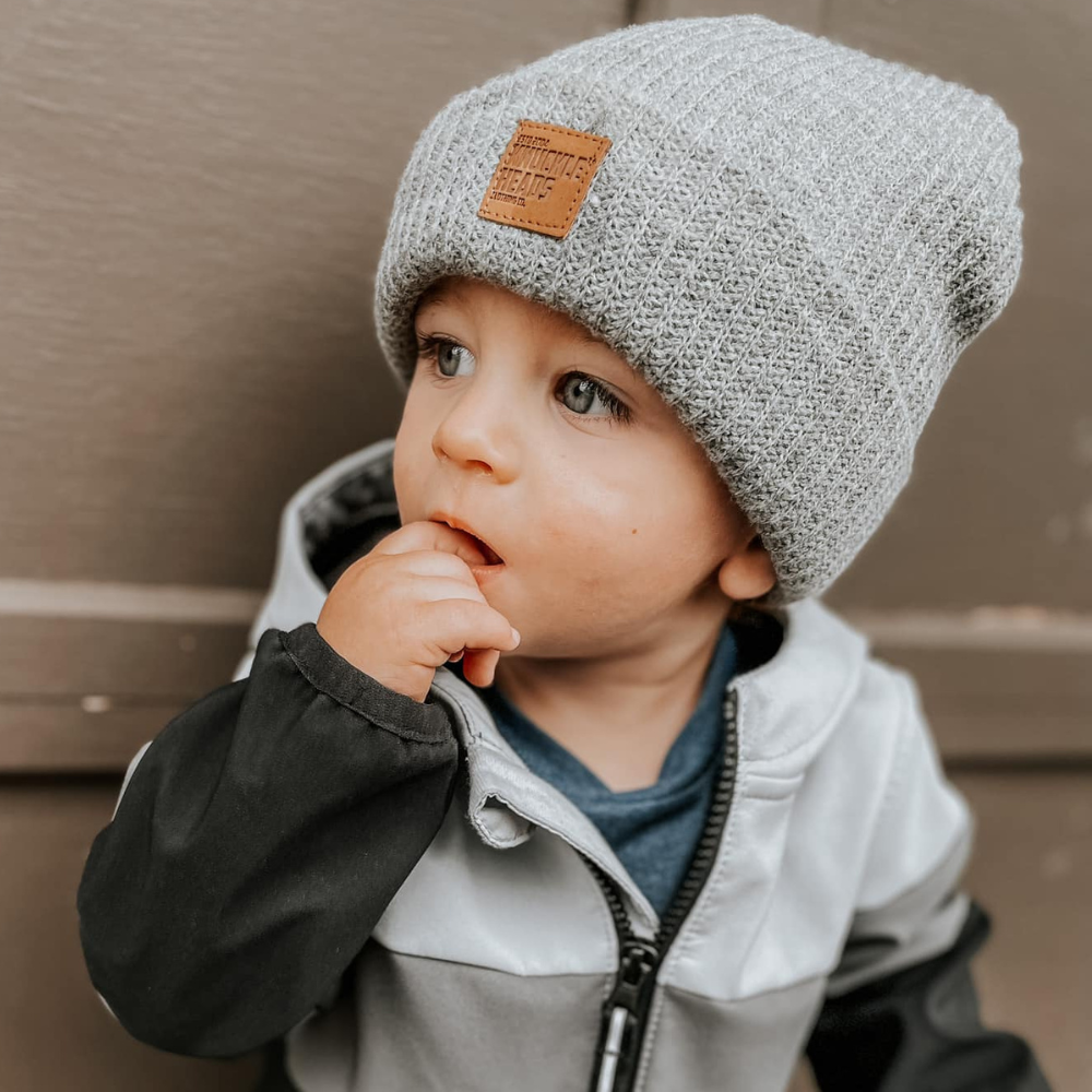 An adorable kids' beanie designed to keep your little one cozy and fashionable, showcasing a stylish Knuckleheads Clothing patch as a standout feature. This trendy addition adds a touch of uniqueness to your child's outfit, making it perfect for both warmth and style. Whether they're heading to school, a playdate, or just out and about, this beanie is the ideal accessory to complete their look.