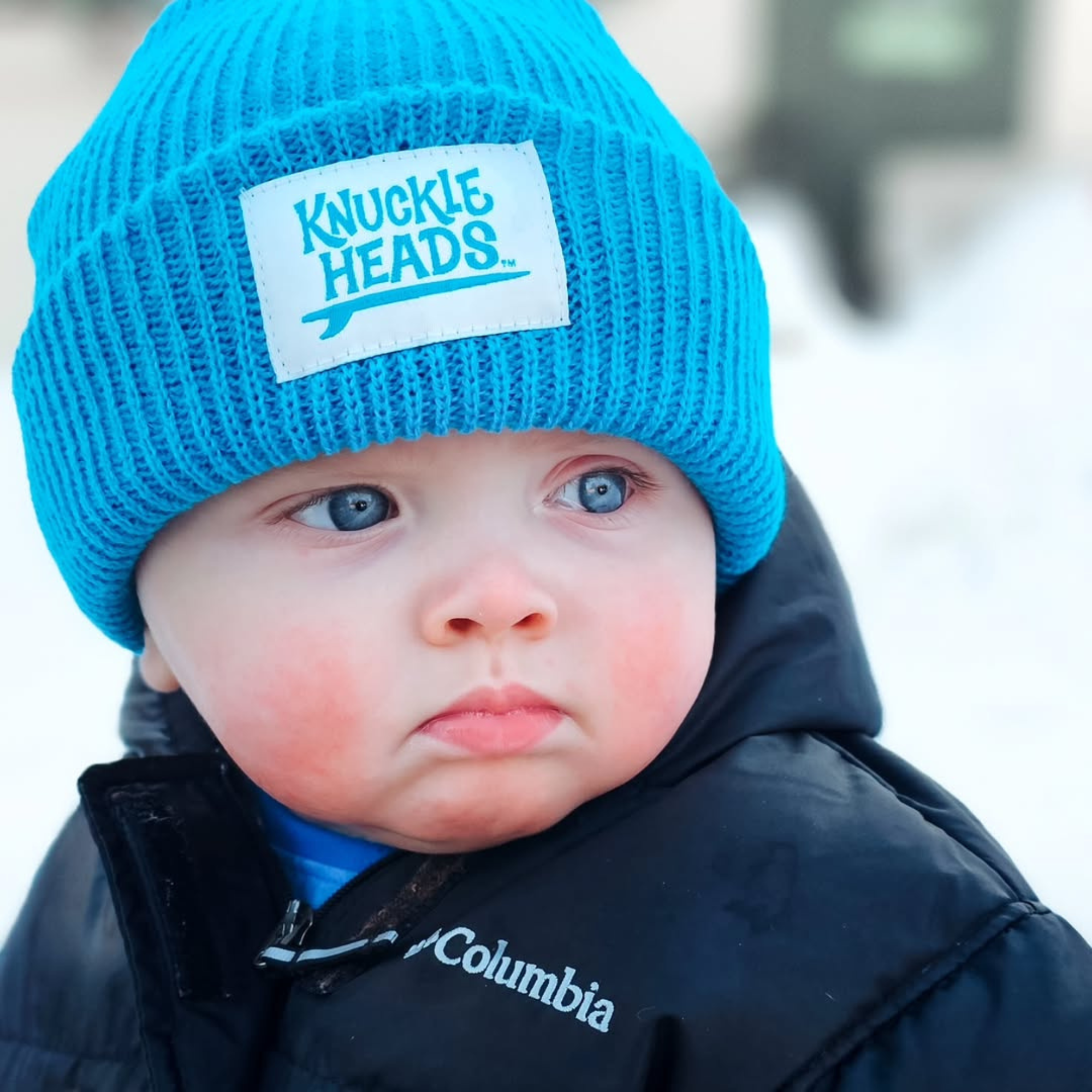 Baby winter hat in electric blue ribbed knit with folded cuff and Knuckleheads label