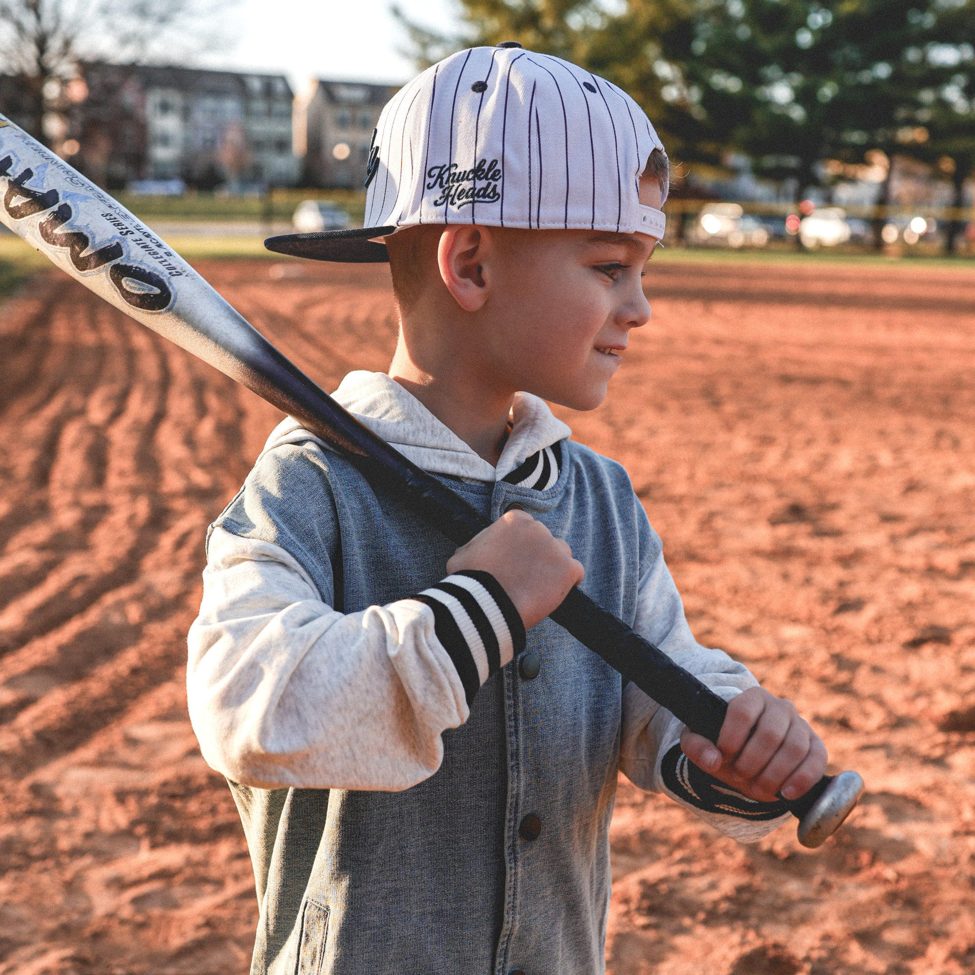 Lifestyle photo of toddler wearing Bubba embroidered snapback hat with navy pinstripes outdoors