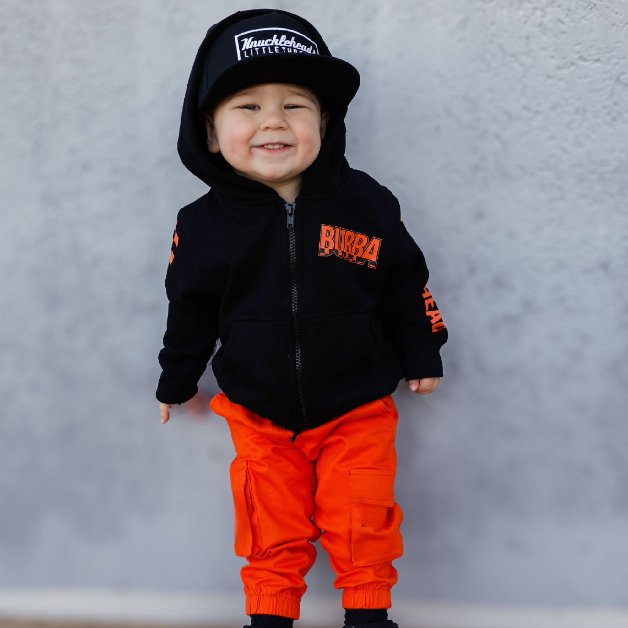 Knuckleheads Kids Bubba Zip Hoodie black graphic sweatshirt with orange logo and checker sleeves for toddlers and youth