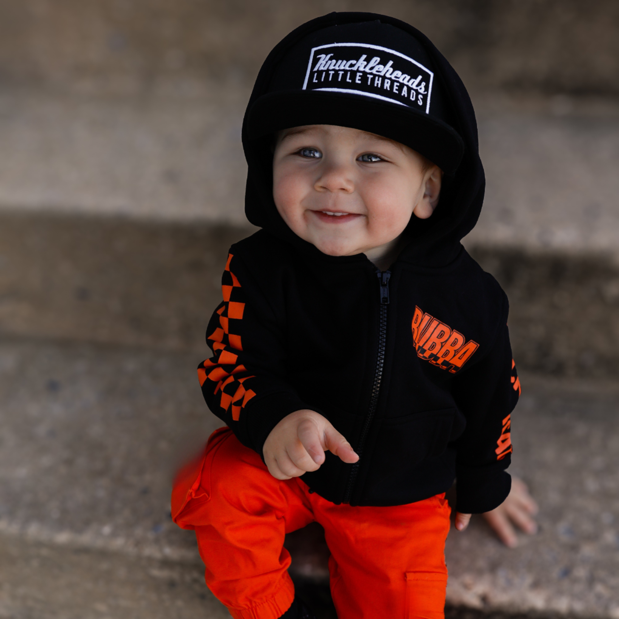 Knuckleheads Kids Bubba Zip Hoodie black graphic sweatshirt with orange logo and checker sleeves for toddlers and youth