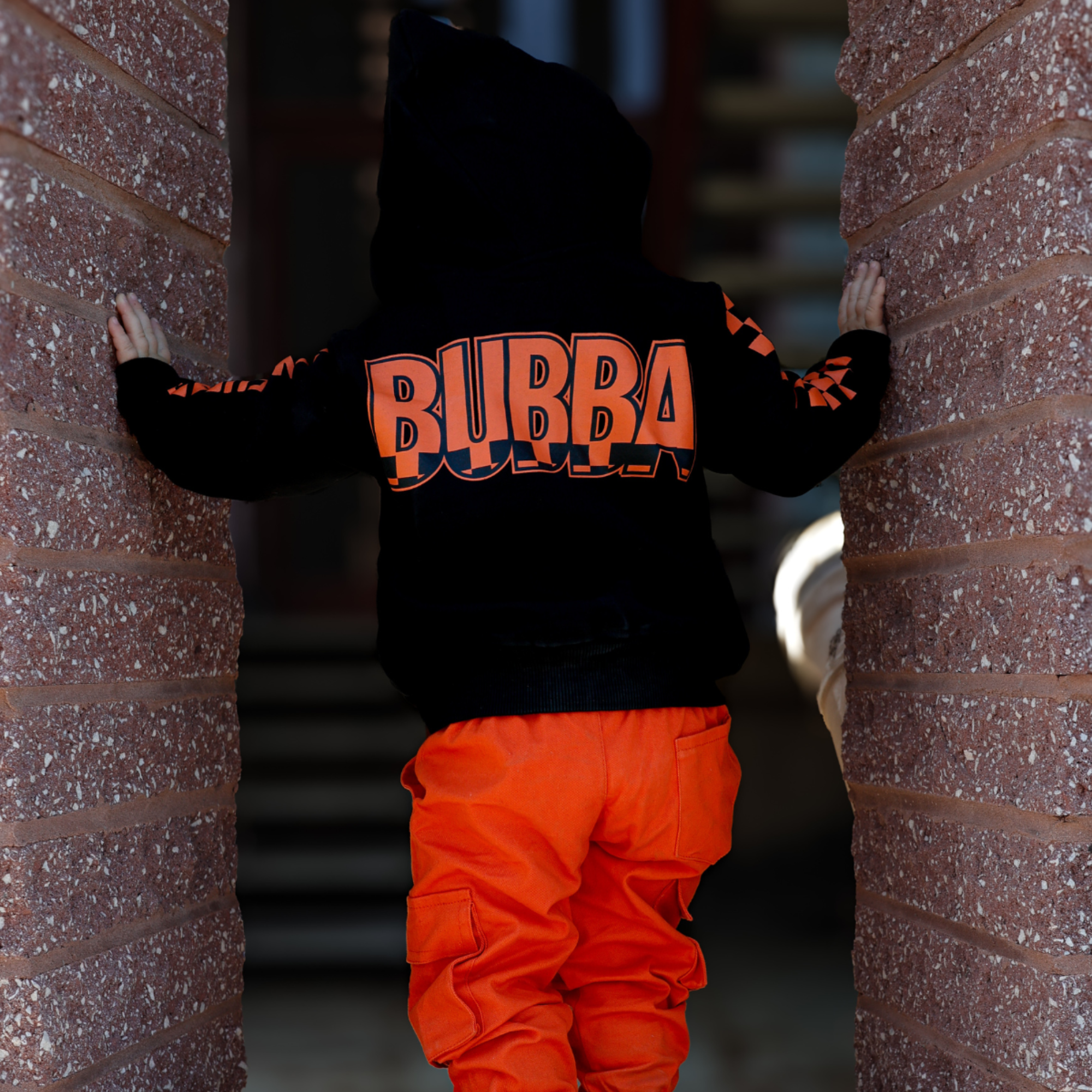 Knuckleheads Kids Bubba Zip Hoodie black graphic sweatshirt with orange logo and checker sleeves for toddlers and youth