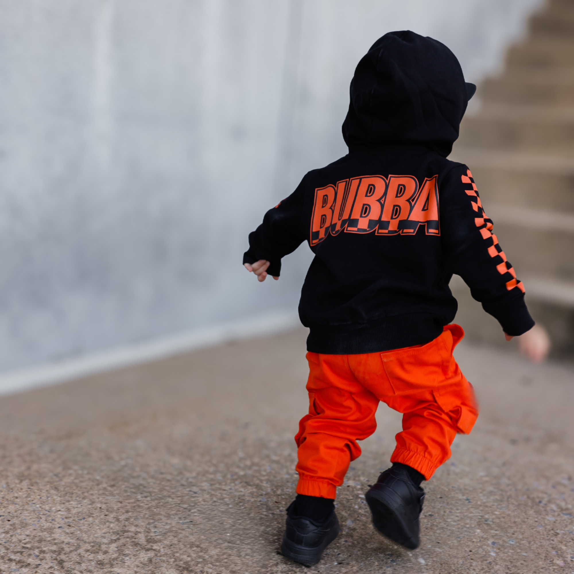 Knuckleheads Kids Bubba Zip Hoodie black graphic sweatshirt with orange logo and checker sleeves for toddlers and youth