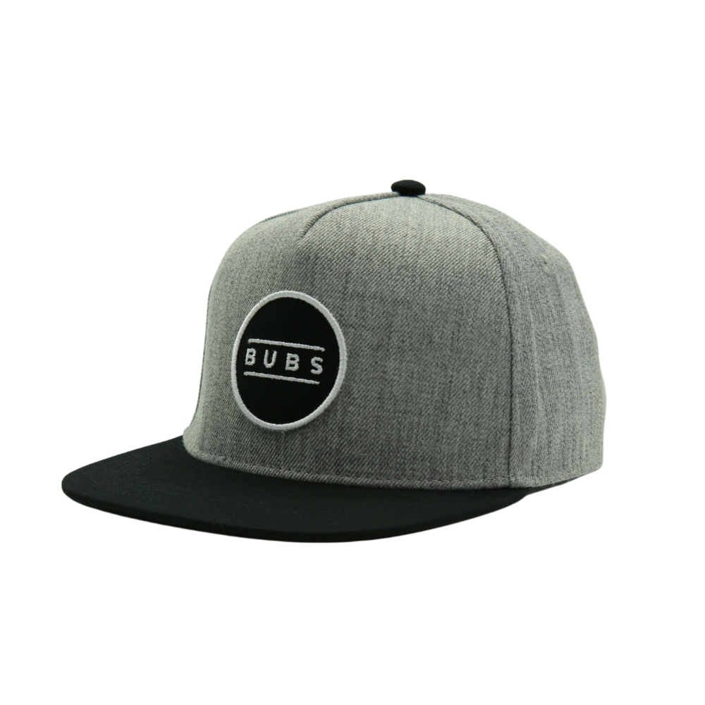 Image showcasing the Kids Trucker Hat in chic grey and black, adorned with a charming 'Bubs' patch. This hat combines versatile grey and black hues with a unique 'Bubs' patch, making it a stylish choice for children. A standout accessory in our collection, it adds a touch of personality and flair to your little one's look.