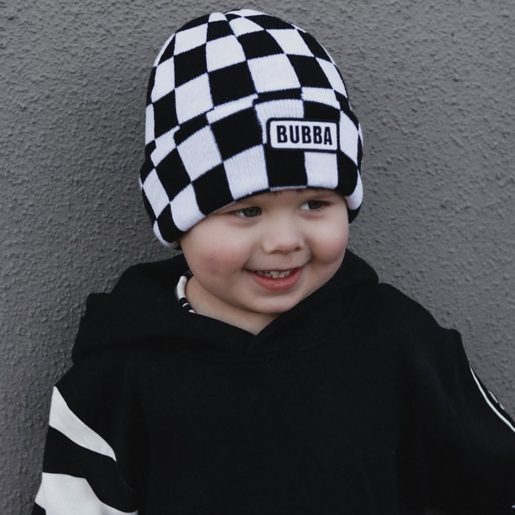 Baby wearing Bubba checkerboard beanie infant and toddler winter hat by Knuckleheads Clothing