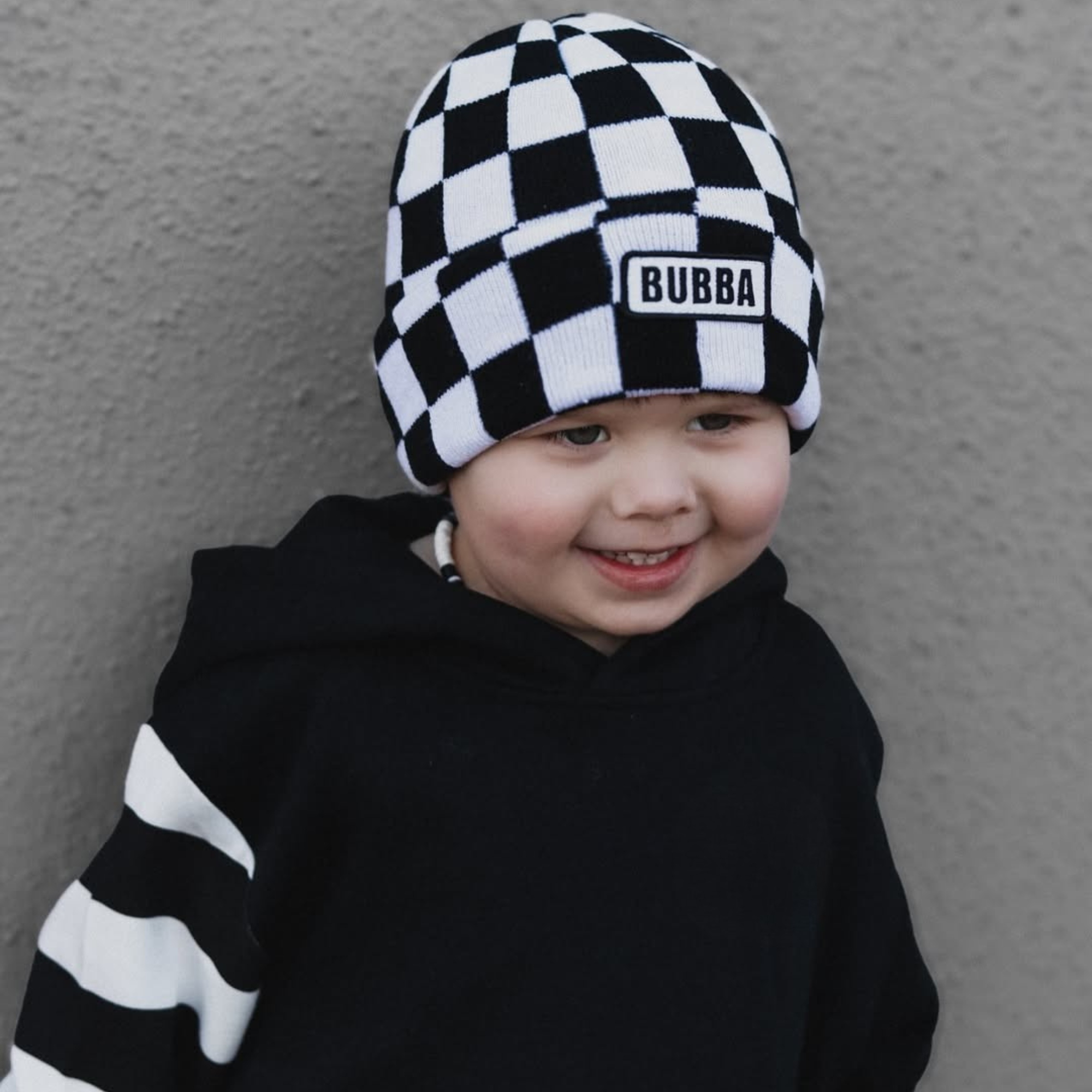 Baby wearing Bubba checkerboard beanie infant and toddler winter hat by Knuckleheads Clothing