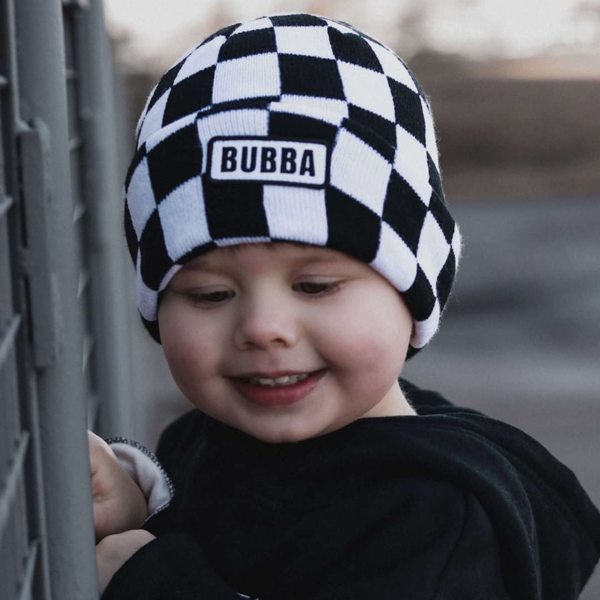 Baby wearing Bubba checkerboard beanie infant and toddler winter hat by Knuckleheads Clothing