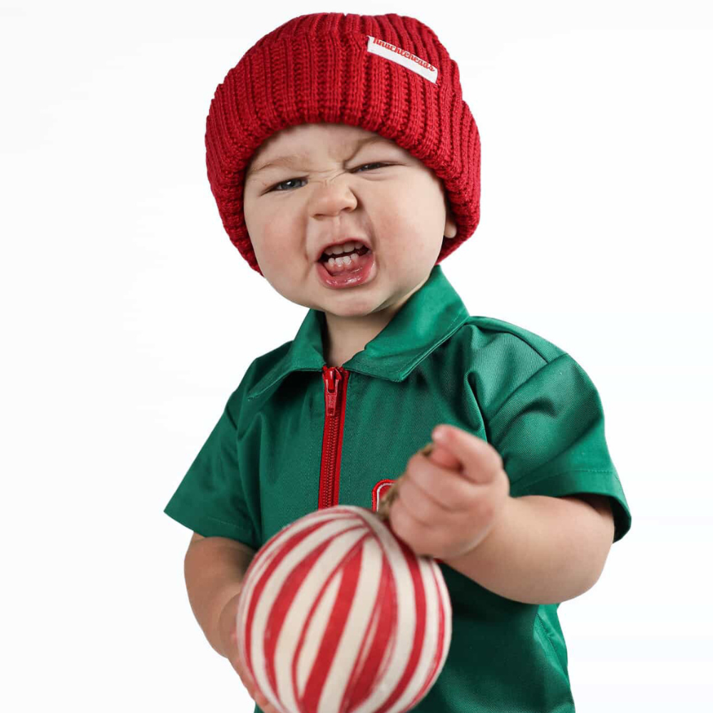 Holiday-themed toddler coverall in bright green with a red zipper and “Holiday Mischief Crew” patch, giving a playful mechanic look perfect for Christmas photos and adventures