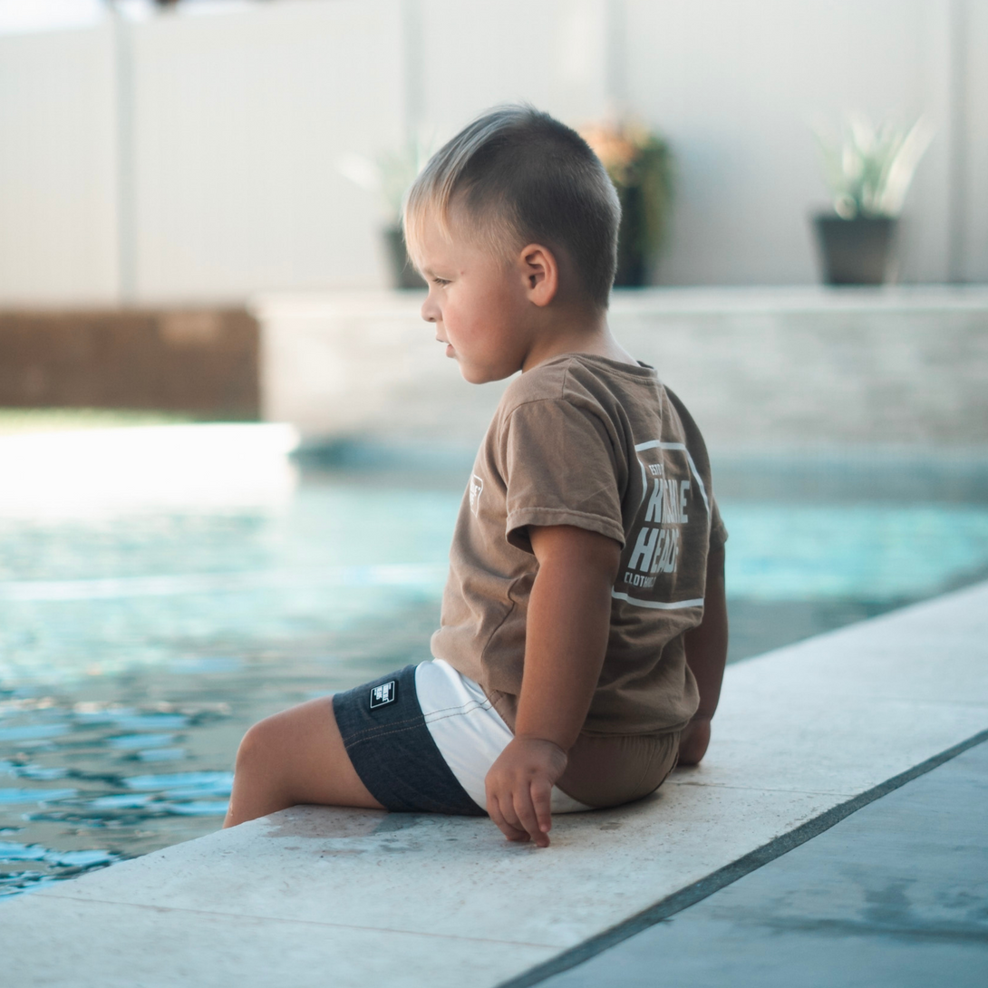 Tan and Black Kids Swim Shorts: Children's swimwear in tan and black color, perfect for fun days at the beach or pool.