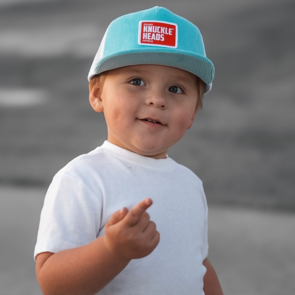 Image of a vibrant Blue and Red Kids Trucker Hat adorned with a Knuckleheads patch and featuring a practical White Sun Mesh. This stylish hat is designed for children, combining eye-catching colors with the distinctive Knuckleheads patch. The addition of white sun mesh not only adds flair but also provides sun protection. It's a standout accessory that adds personality and practicality to your little one's look.