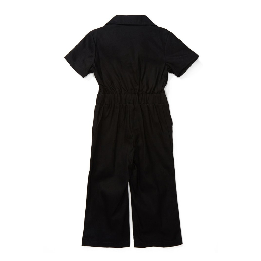 This image showcases delightful black kids' coveralls adorned with a charming Knuckleheads patch, adding a touch of whimsy to your child's wardrobe. These coveralls are not only fashionable but also comfortable, making them an ideal choice for your little one's everyday adventures.