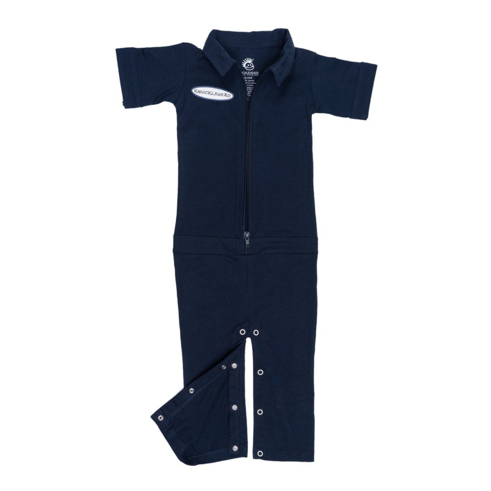 This image showcases delightful navy kids' coveralls adorned with a charming Knuckleheads patch, adding a touch of whimsy to your child's wardrobe. These coveralls are not only fashionable but also comfortable, making them an ideal choice for your little one's everyday adventures.