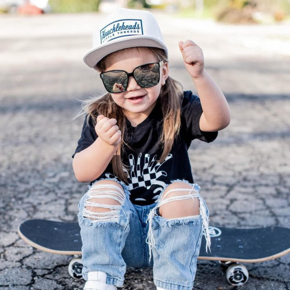 Elevate your child's style with our Hazel Sunglasses For Kids, featuring a sleek Black finish and iconic Knuckleheads logo on the temples. Crafted with excellent quality and UV protection, they're designed to fit all sizes comfortably and delivered in a fabric pouch for added convenience.