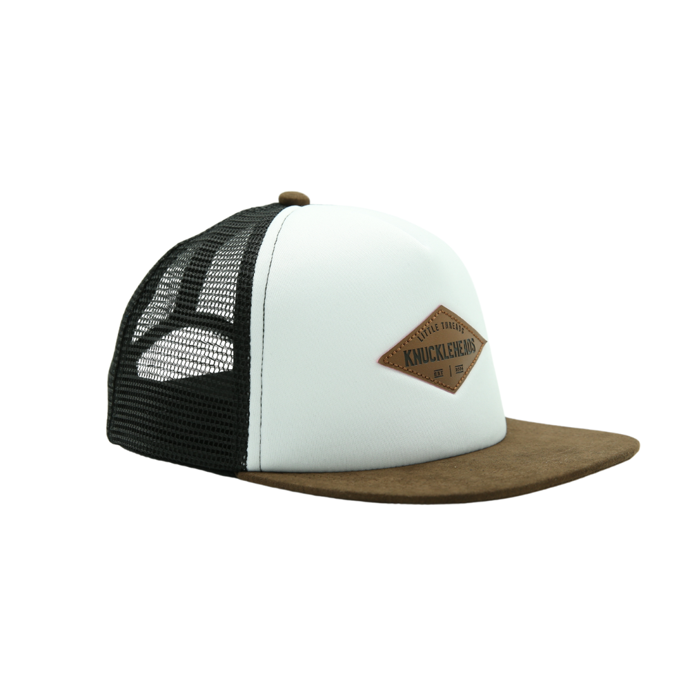 Image of White with Brown Bill Kids Trucker Hat with Troublemaker Patch: A cool and trendy trucker hat designed for kids. The hat features a stylish black crown and a brown bill, adorned with a striking Knuckleheads patch on the front. Elevate your child's style with this fashionable and comfortable accessory, perfect for any adventure or everyday wear. Crafted with care, this black with brown bill trucker hat with a Knuckleheads patch is a must-have addition to their wardrobe.