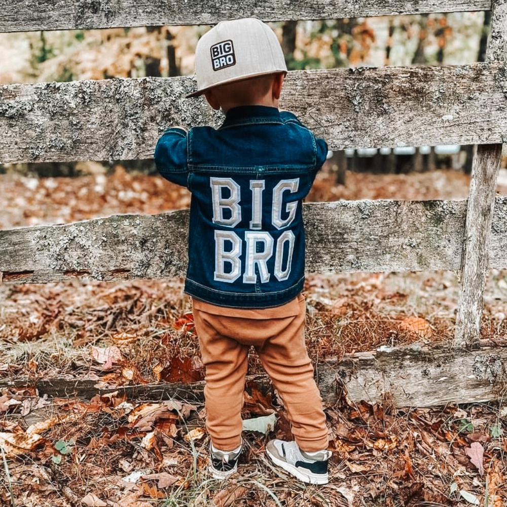 Introducing a Kids Trucker Hat with a 'Big Bro' patch, a heartwarming and fun addition to our collection. This hat is designed especially for children, featuring the endearing 'Big Bro' patch that lets your little one proudly showcase their big sibling status. It's a standout accessory that adds personality and style to your child's look.