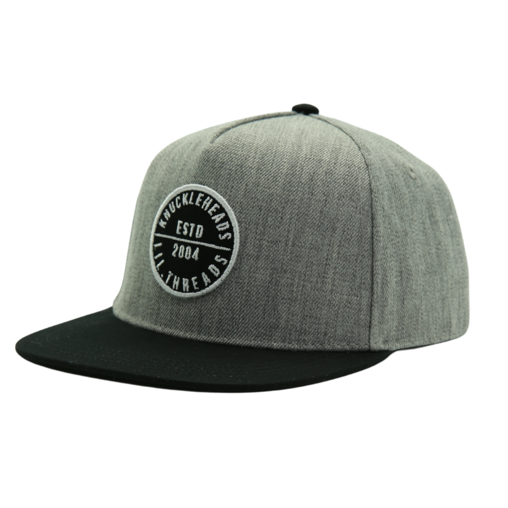 Presenting a Kids Trucker Hat in stylish Black and Grey, featuring an iconic Knuckleheads patch. This hat is specially designed for children, combining the versatile black and grey tones with the classic Knuckleheads patch. A standout accessory in our collection, it adds a touch of coolness and personality to your little one's look.