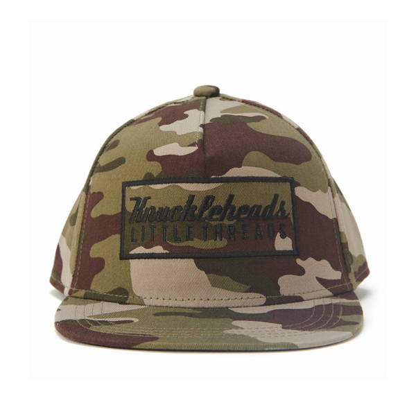 Image of Camo Kids Trucker Hat with Black Rectangle Knuckleheads Patch: A rugged and stylish accessory designed for kids. In a classic camo pattern, it features a bold black rectangle Knuckleheads patch on the front. Elevate your child's style with this fashionable hat, perfect for adding a touch of outdoor charm to their outfits.