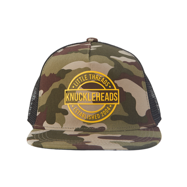 Image of Camo Kids Trucker Hat with Black Mesh and Gold Round Knuckleheads Patch: A rugged and stylish accessory designed for kids. In a classic camo pattern with black mesh, it features a distinctive gold round Knuckleheads patch on the front. Elevate your child's style with this fashionable hat, perfect for adding a touch of outdoor charm to their outfits.