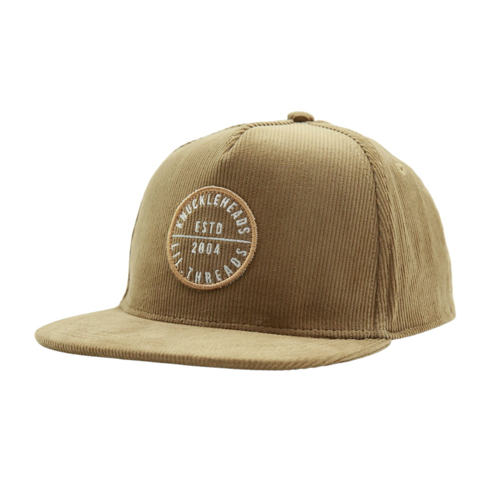 Introducing a Kids Trucker Hat in cozy Corduroy Camel, featuring an iconic Knuckleheads patch. This hat is specially designed for children, combining the warmth and style of corduroy with the classic Knuckleheads patch. A standout accessory in our collection, it adds a touch of charm and personality to your little one's look.