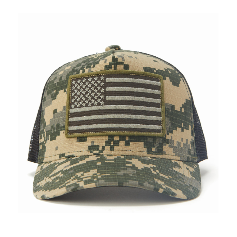 Image of Camo Kids Trucker Hat with Black Mesh and USA Flag Patch: A patriotic and stylish accessory designed for kids. In a captivating camo pattern with sleek black mesh, it features a prominent USA flag patch on the front. Elevate your child's style with this fashionable hat, perfect for adding a touch of national pride to their outfits while ensuring breathability.