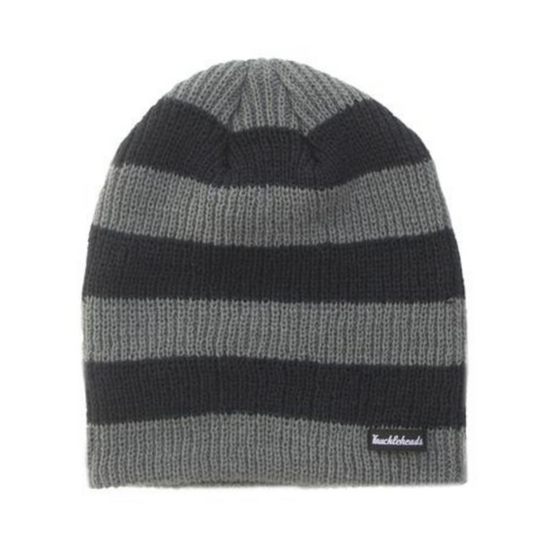Photo of a striped beanie in shades of black and grey, featuring a prominent Knuckleheads tag. The beanie is laid out on a flat surface, showcasing its unique pattern and tag detail.