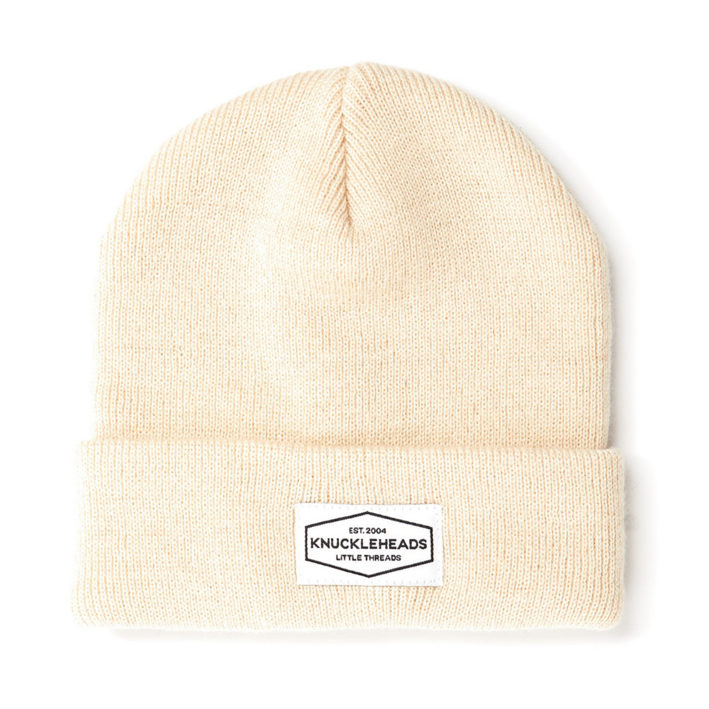 Image of Tan Kids Beanie with Knuckleheads Logo: This green beanie is both stylish and cozy for kids. The Knuckleheads logo on the front adds a unique touch to their outfits while keeping them warm. Crafted with care, this beanie is a versatile addition to their winter wardrobe, suitable for various occasions and everyday wear.