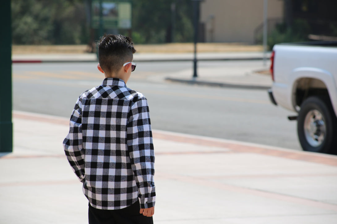Image of a long sleeve shirt from Knuckleheads Clothing, showcasing a captivating black and white checkerboard pattern. The design exudes a confident and edgy style, making it a bold fashion choice.