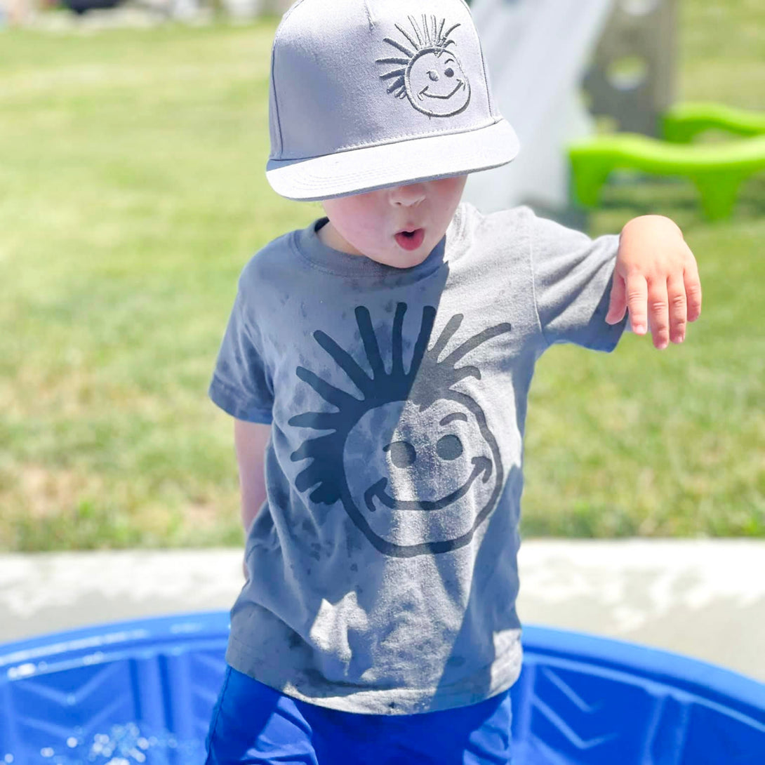 Image of Grey Kids Trucker Hat with Knuckleheads Logo: A stylish and versatile accessory designed for kids. In sleek grey, it showcases the iconic Knuckleheads logo on the front. Elevate your child's style with this fashionable hat, perfect for adding a touch of edgy flair to their outfits. 