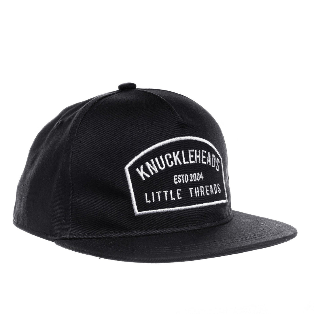 Image of Black Kids Trucker Hat with Knuckleheads Patch: A cool and trendy trucker hat designed for kids. The hat comes in sleek black, showcasing a striking Knuckleheads patch on the front. Elevate your child's style with this fashionable and comfortable accessory, perfect for any adventure or everyday wear. Crafted with care, this black trucker hat with a Knuckleheads patch is a must-have addition to their wardrobe.